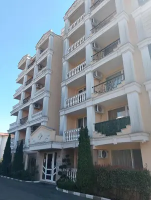 a large white building with balconies and trees at Studio Apartment Villa Sardinia Sveti Vlas in Sveti Vlas