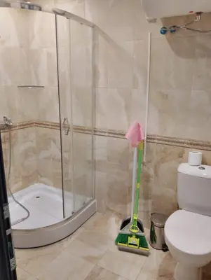 a bathroom with a shower and a toilet with a mop at Studio Apartment Villa Sardinia Sveti Vlas in Sveti Vlas