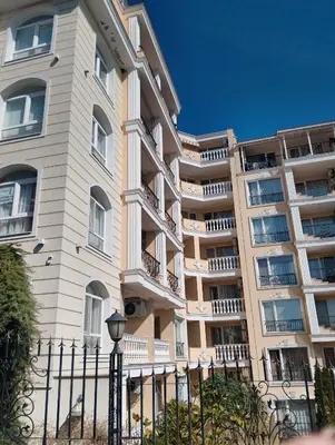 a tall building with a fence in front of it at Studio Apartment Villa Sardinia Sveti Vlas in Sveti Vlas
