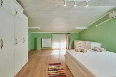 a bedroom with green walls and a large bed at Florance Rentals Luxury Apartments in Nessebar in Nesebar