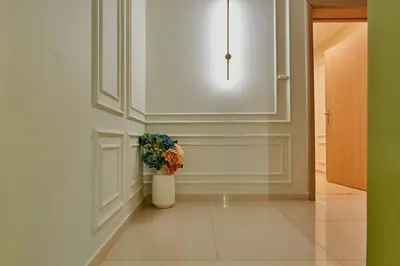 a hallway with a potted plant on the wall at Florance Rentals Luxury Apartments in Nessebar in Nesebar