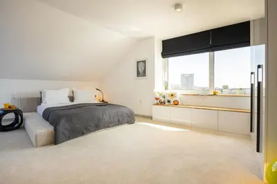 a bedroom with a bed and a window at Apartment Musala N 05 in Varna City