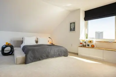 a bedroom with a bed and a large window at Apartment Musala N 05 in Varna City