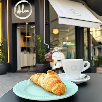 a plate with a croissant and a cup of coffee at Apartment Musala N 06 in Varna City