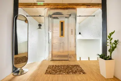 a hallway with a glass door and a mirror at Apartment Musala N 06 in Varna City