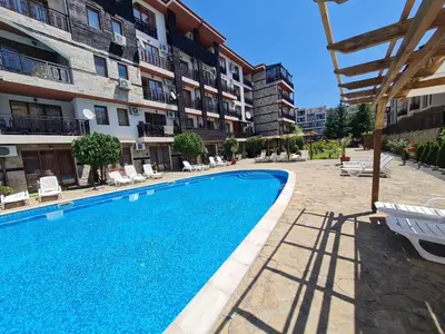 a swimming pool in front of a building at MitProt Panorama Bay 2 Apartment 74 in Sveti Vlas