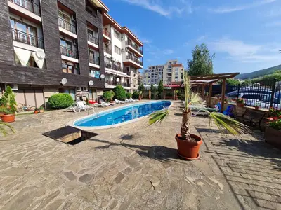 a palm tree in a pot next to a swimming pool at MitProt Panorama Bay 2 Luks Studio 32 in Sveti Vlas