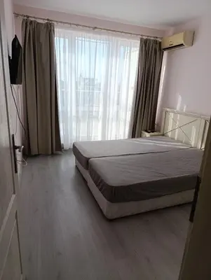 a bedroom with a bed and a large window at Sunny Beach Center Apartment in Sunny Beach