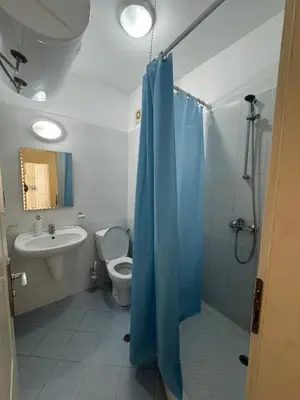 a bathroom with a shower and a toilet and a sink at Sunny Beach Center Apartment in Sunny Beach