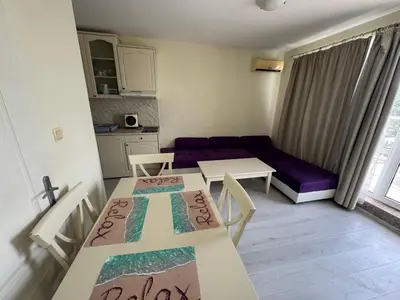 a living room with two tables and a couch at Sunny Beach Center Apartment in Sunny Beach