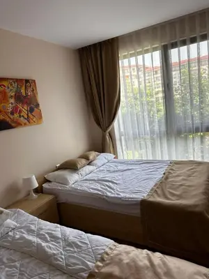 a bedroom with two beds and a window at Premier Fort Beach Hotel in Sveti Vlas