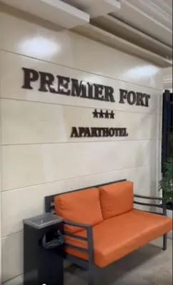 an orange bench sitting in front of a sign at Premier Fort Beach Hotel in Sveti Vlas