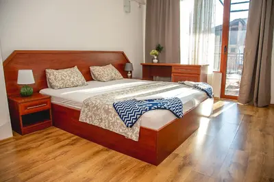 a bedroom with a large wooden bed and a window at Nessebar's NEW Town TOP Centre 2-BDR Apartment by Flаt Manаger in Nesebar