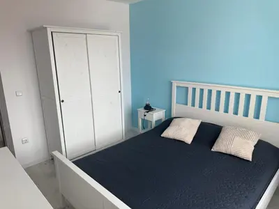 a bedroom with a bed and a white cabinet at Lora - Tsarevo in Tsarevo