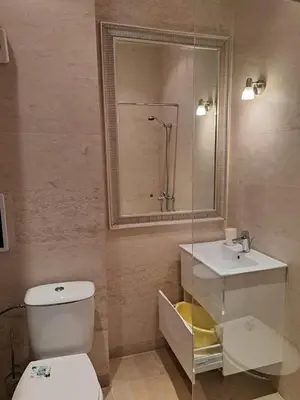 a bathroom with a toilet and a sink and a mirror at Амара Б3 студия in Sunny Beach