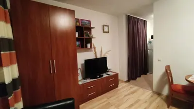 a living room with a television on a wooden cabinet at Holiday Fort Golf Club MIA 2 in Sunny Beach