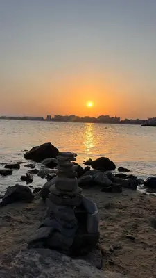 a stack of rocks on the beach at sunset at Holiday Fort Golf Club MIA 2 in Sunny Beach