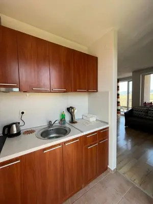 a kitchen with a sink and wooden cabinets at Holiday Fort Golf Club MIA 2 in Sunny Beach