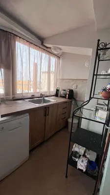 a kitchen with a shelf next to a sink at Cozi 2BD Apartment with Sea View in the Old Town of Sozopol in Sozopol