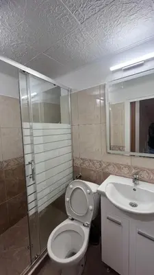 a bathroom with a toilet and a sink at Cozi 2BD Apartment with Sea View in the Old Town of Sozopol in Sozopol