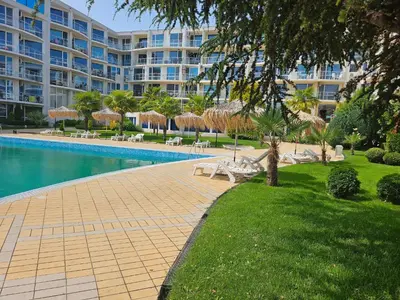 a resort with a swimming pool and a large building at Студио за нощувки в Сарафово in Burgas City