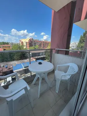 a white table and chairs on a balcony with a view at Студия в Болгарии Солнечный берег in Sunny Beach