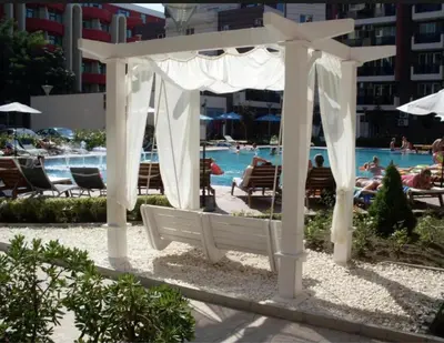 a white gazebo in front of a pool at Студия в Болгарии Солнечный берег in Sunny Beach
