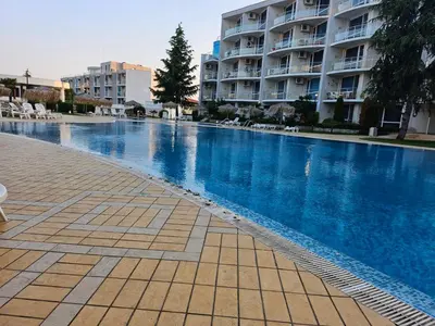 a large swimming pool in front of a building at Студио за гости на Сарафово in Burgas City