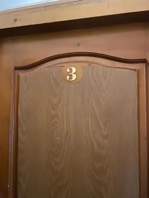 a brown door with the number three on it at Art Luxury studio in Burgas City