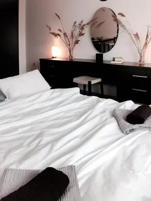 a white bed in a bedroom with a mirror at Boho Studio 4 pools 10min to the beach in Burgas City