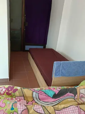 a bedroom with a bed with a blanket on the floor at На пъпа на Варна, голяма стая! in Varna City