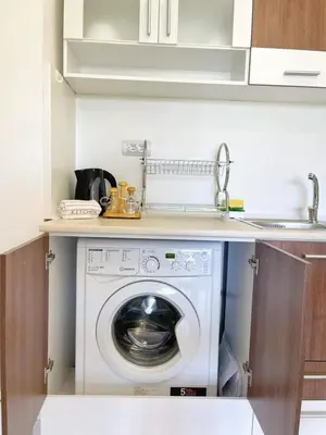a washing machine in a kitchen with a sink at К-с Сън Коуст in Sveti Vlas