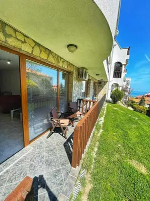 a patio with chairs and tables on the side of a house at К-с Сън Коуст in Sveti Vlas