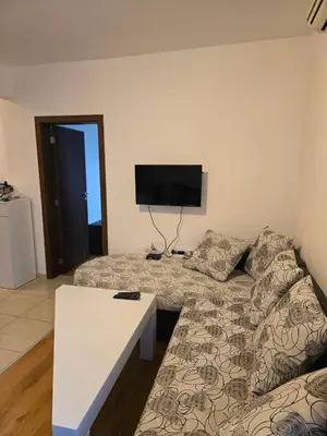 a living room with a couch and a flat screen tv at Sea Diamond Family Suite in Sunny Beach
