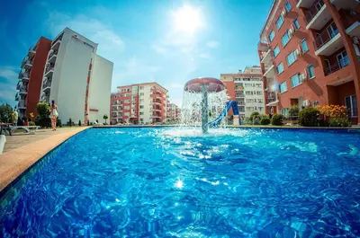 a fountain in the middle of a swimming pool at Cozy Apartment in Grand Fort Noks with Sea View in Sveti Vlas
