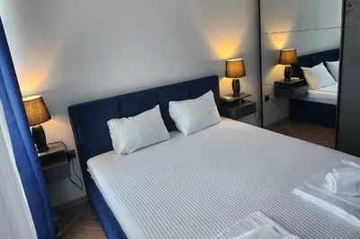 a bedroom with a large bed with two white pillows at Апартамент на център Приморско in Primorsko