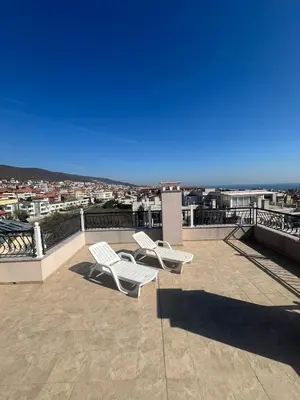 two white chairs sitting on top of a roof at Modern Penthouse Apartment with full Sea View K&R in Sveti Vlas
