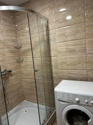 a bathroom with a washing machine and a washer at Premier Fort Beach Hotel in Sveti Vlas