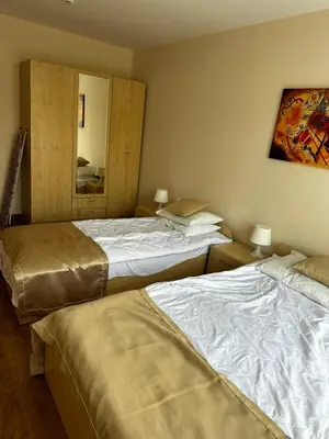 a bedroom with two beds and a mirror at Premier Fort Beach Hotel in Sveti Vlas