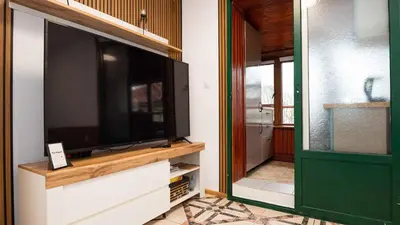 a large flat screen tv sitting on top of a cabinet at Апартамент Уютна почивка in Burgas City