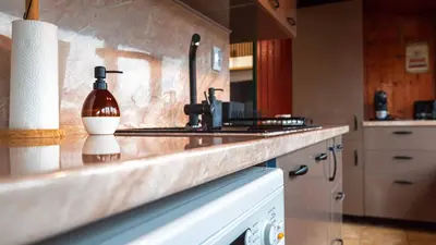a kitchen with a sink and a counter top at Апартамент Уютна почивка in Burgas City