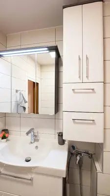 a bathroom with a sink and a mirror at Апартамент Уютна почивка in Burgas City