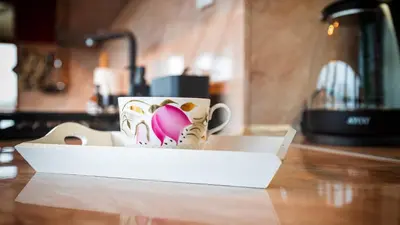a coffee cup sitting in a box on a table at Апартамент Уютна почивка in Burgas City