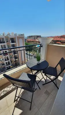 a balcony with a table and chairs on a balcony at Sunshine Rose - Sea view, Neubau, Luxus Apartment in Sveti Vlas
