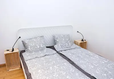 a bedroom with a bed and two night stands at Verano Azul - Adorable Flat in Unbeatable Location by Flat Mаnager in Varna City