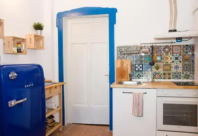 a kitchen with a blue refrigerator in a room at Verano Azul - Adorable Flat in Unbeatable Location by Flat Mаnager in Varna City
