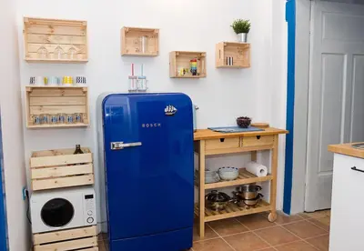 an old blue refrigerator in a kitchen next to a table at Verano Azul - Adorable Flat in Unbeatable Location by Flat Mаnager in Varna City