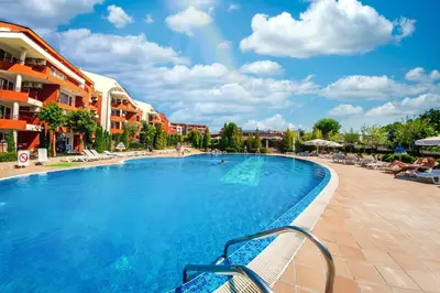 a swimming pool at a resort with chairs and buildings at Green Fort Noks - Private apartment - BSR - 3 in Sunny Beach
