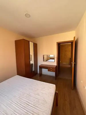 an empty room with a bed and a mirror at Privilege First Line Sea in Elenite