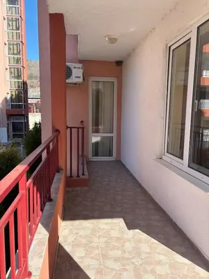 a balcony of a building with a door and windows at Privilege First Line Sea in Elenite